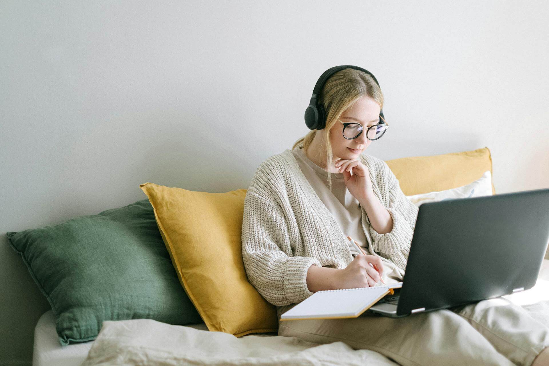 Remote typing job setup with laptop and headphones